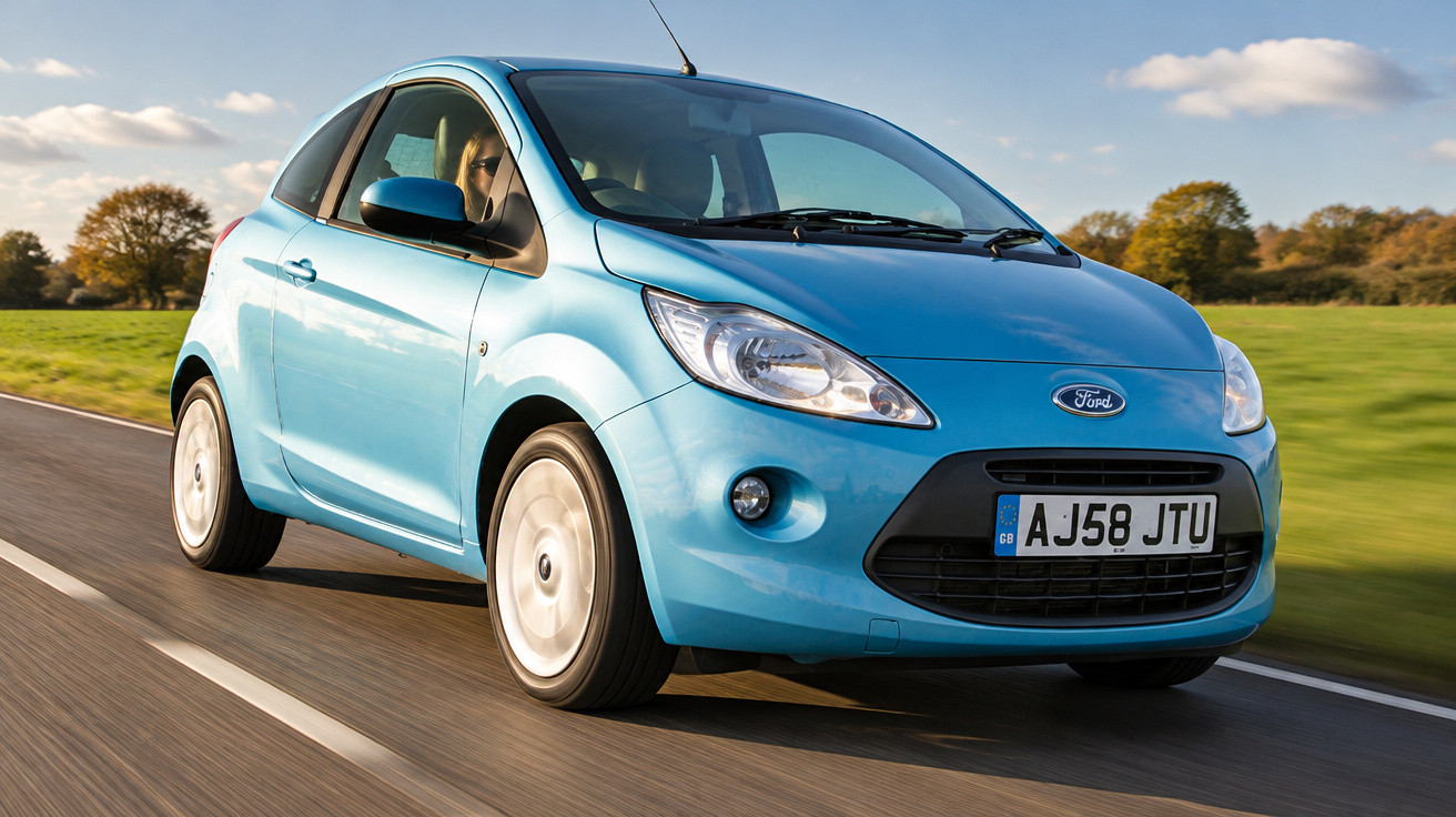 Blue Ford Ka driving on a rural road with green fields and trees in the background.