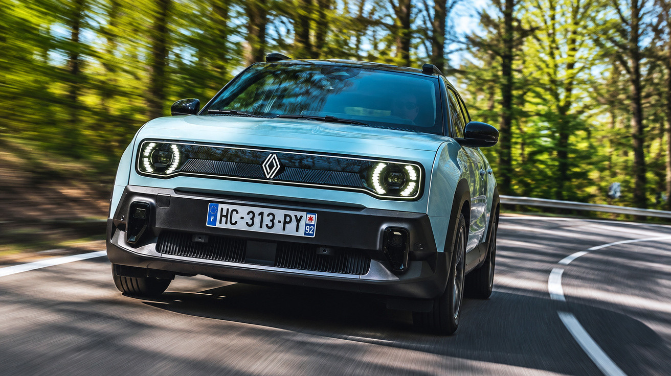 Front view of a modern compact electric car driving on a curvy forest road during daytime.